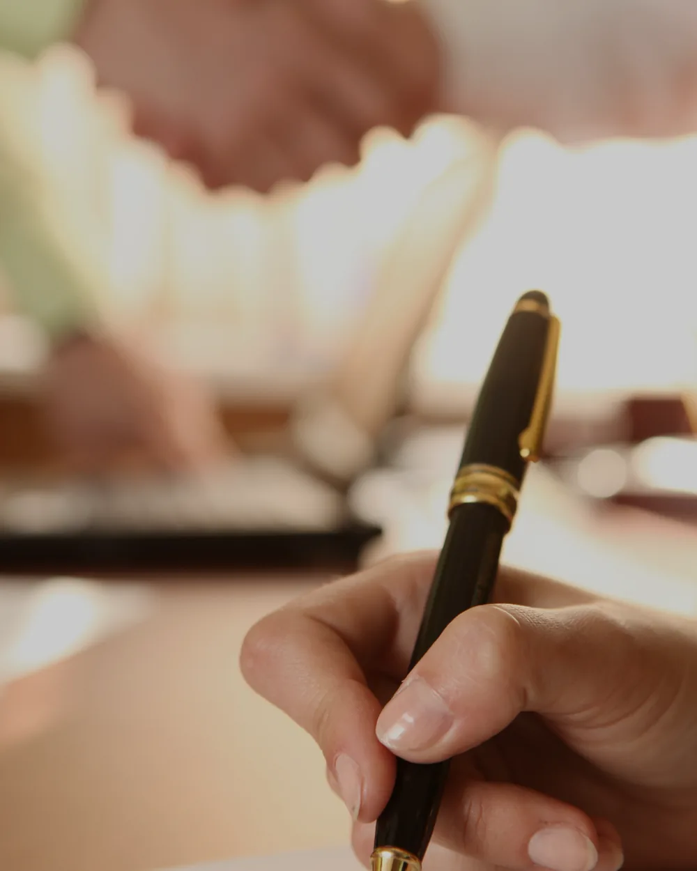 Agent signing an offer after a handshake